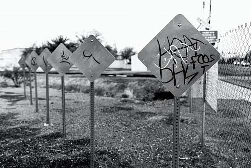 road sign greyscale photo of signages sign